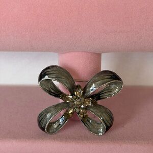 Vintage flower-shaped brooch, characterized by its brushed